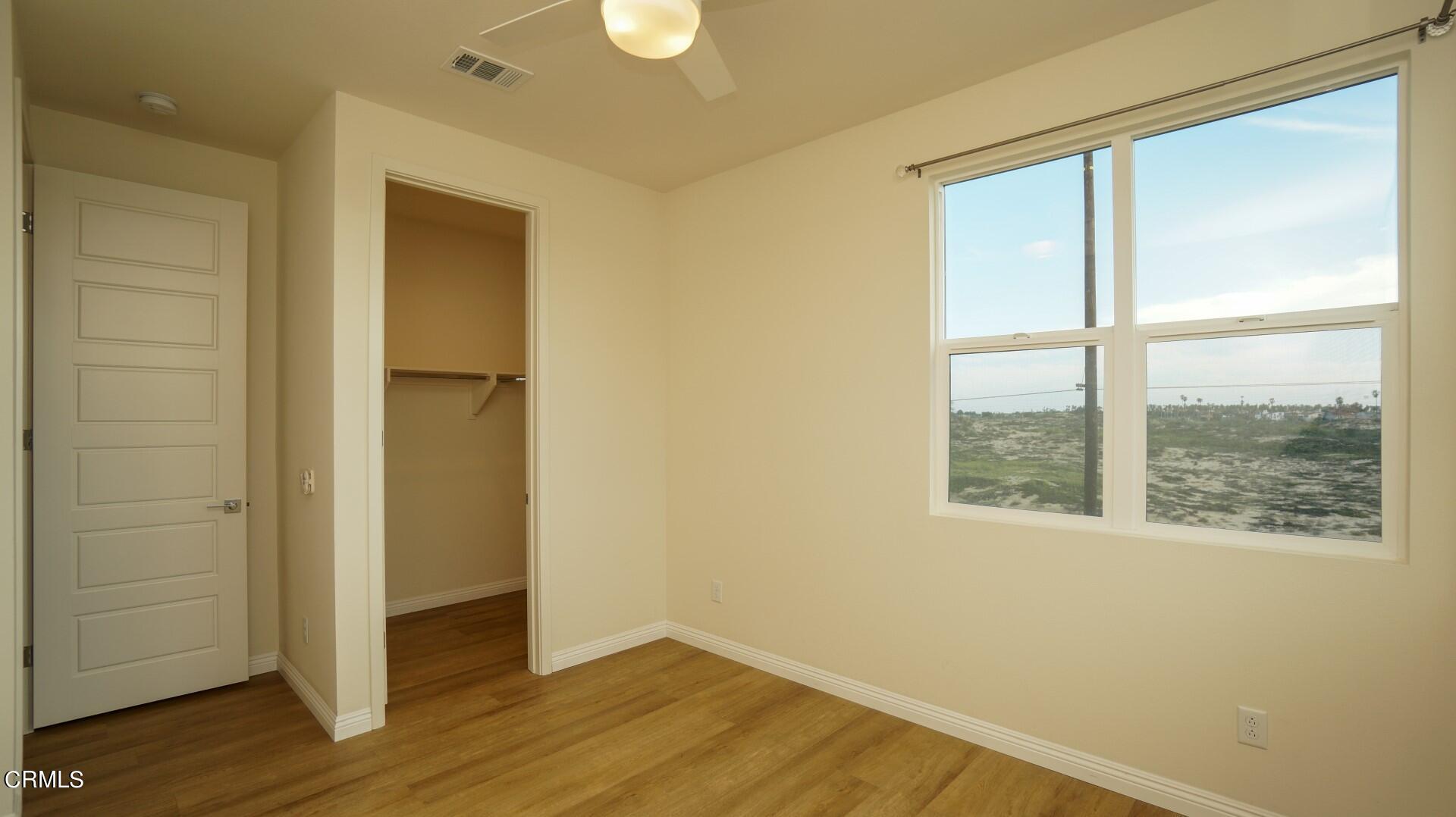 1063 Canal Street Oxnard, CA 93035 - Photo 20 of 32 an empty room with wooden floor and windows