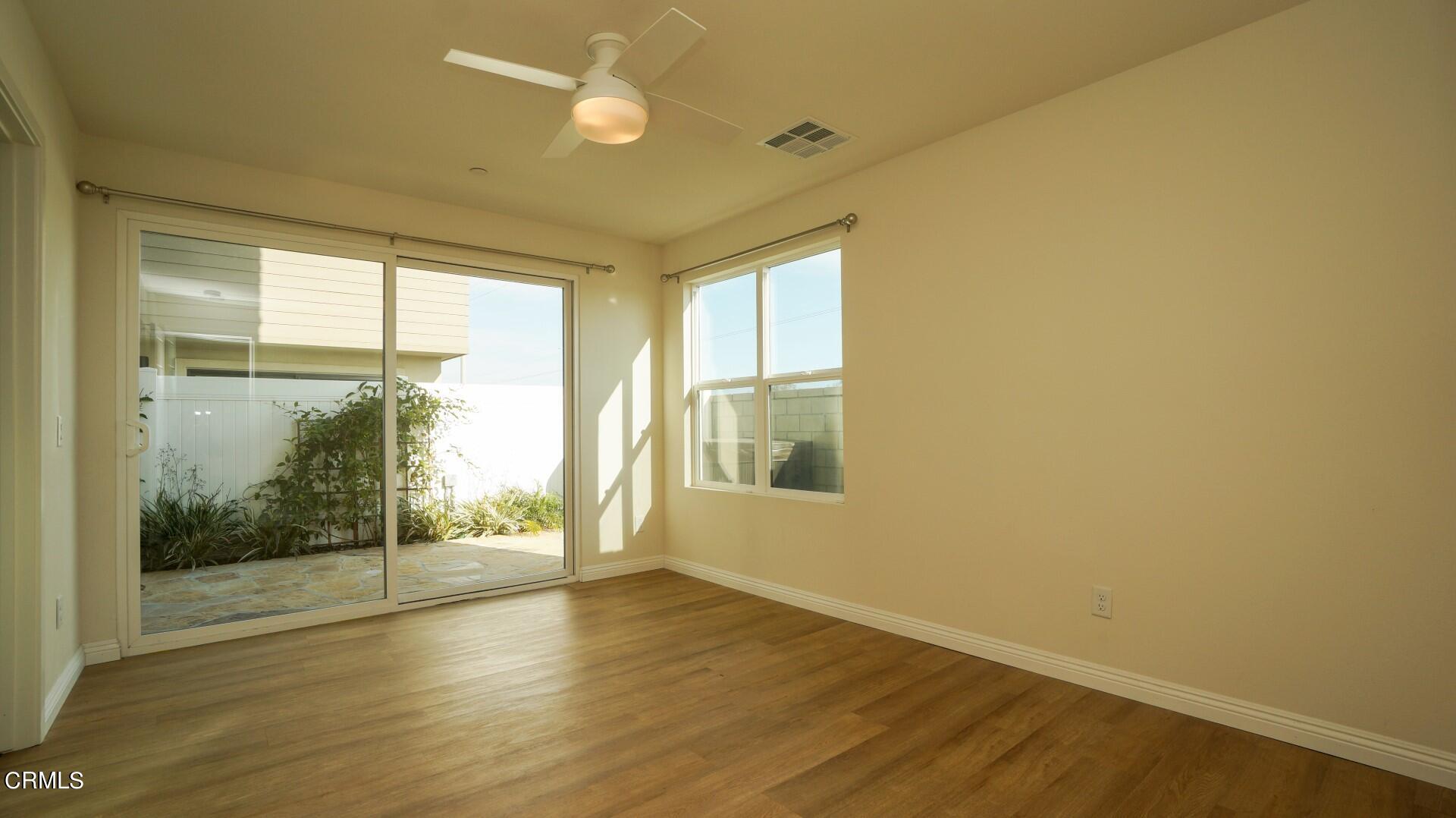 1063 Canal Street Oxnard, CA 93035 - Photo 25 of 32 an empty room with wooden floor and windows