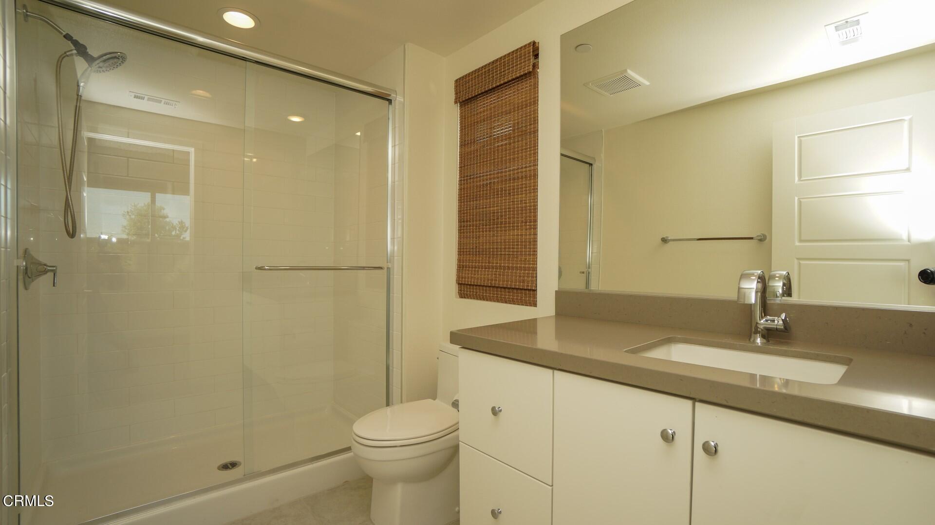 1063 Canal Street Oxnard, CA 93035 - Photo 27 of 32 a bathroom with a granite countertop sink toilet and shower