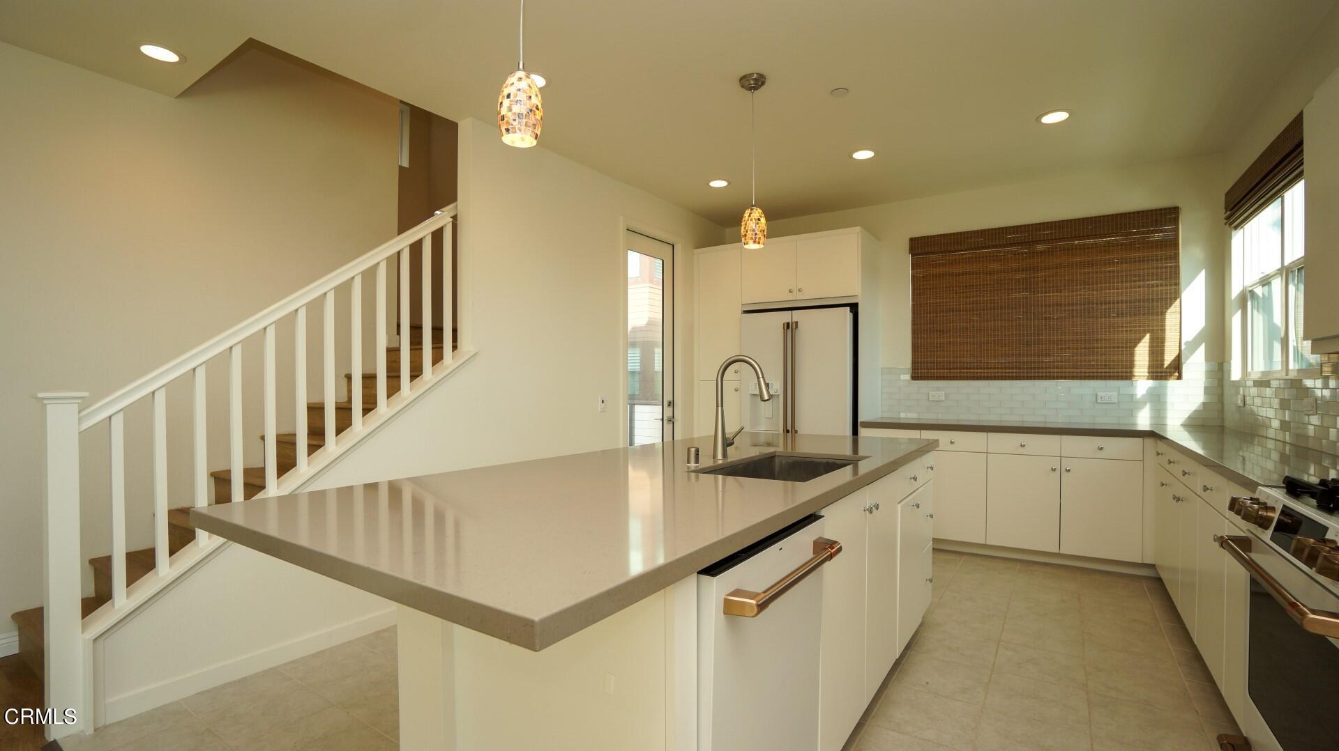 1063 Canal Street Oxnard, CA 93035 - Photo 4 of 32 a kitchen with counter top space and windows