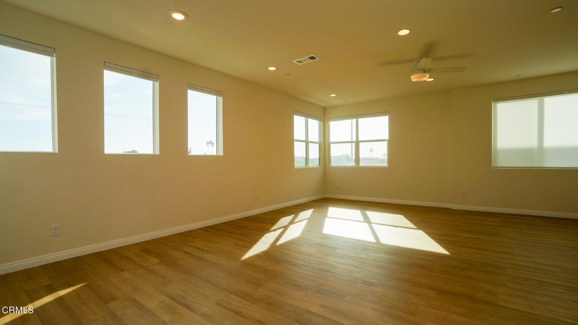 1063 Canal Street Oxnard, CA 93035 - Photo 9 of 32 a view of an empty room with wooden floor and a window