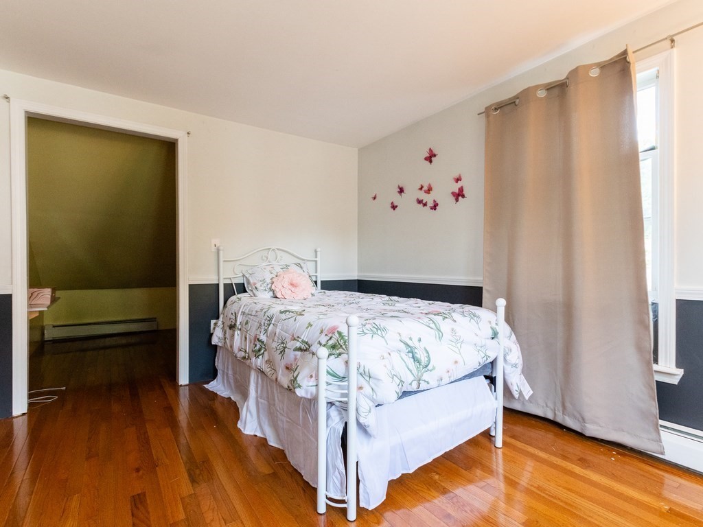 2 Columbia Road Billerica, MA 01821 - Photo 11 of 30 a bed sitting in a bedroom next to a window