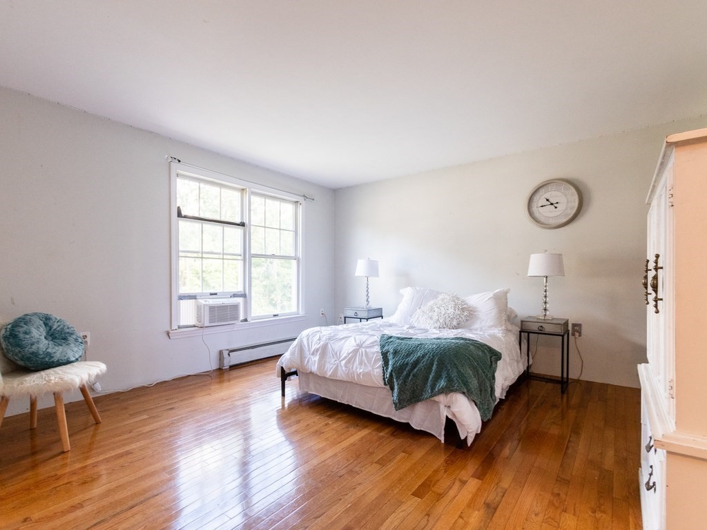 2 Columbia Road Billerica, MA 01821 - Photo 12 of 30 a bedroom with a bed and wooden floor