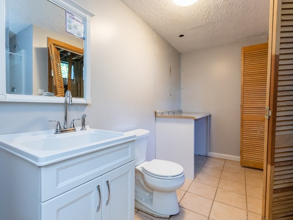 2 Columbia Road Billerica, MA 01821 - Photo 20 of 30 a bathroom with a sink a toilet and mirror