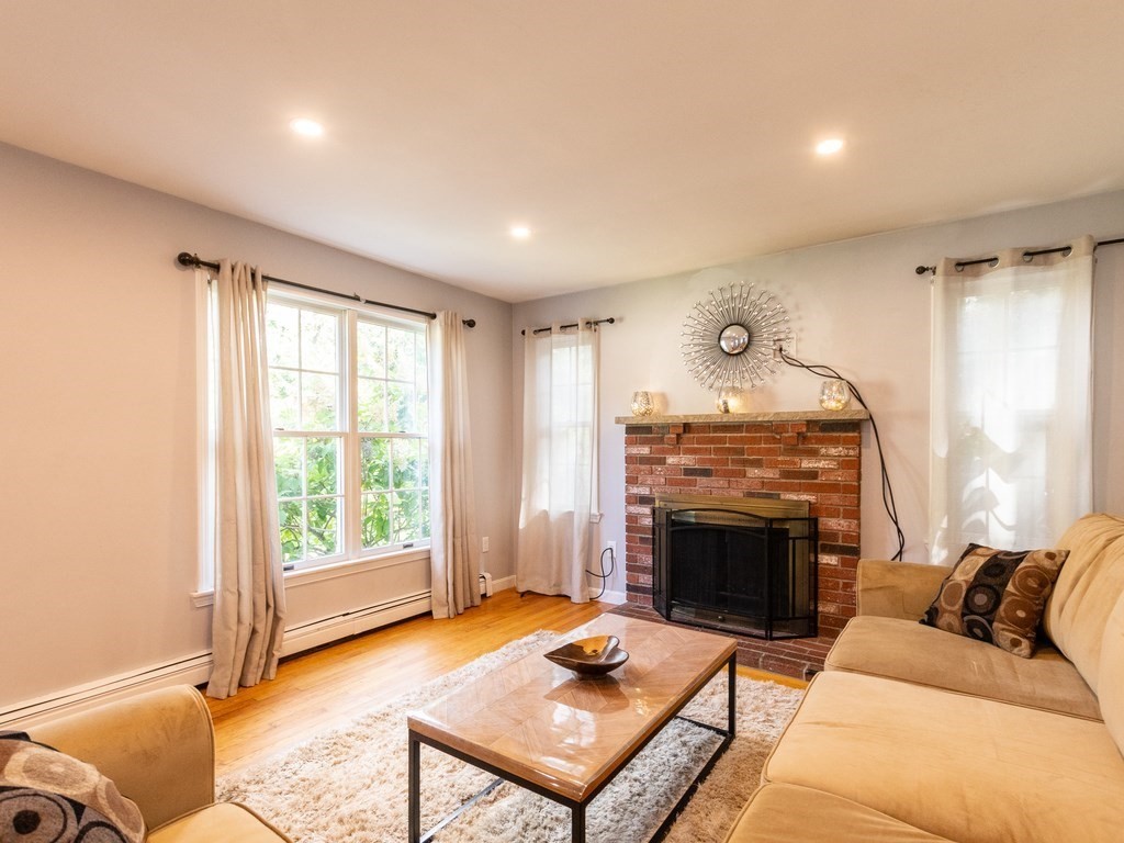 2 Columbia Road Billerica, MA 01821 - Photo 3 of 30 a living room with furniture a window and a fireplace