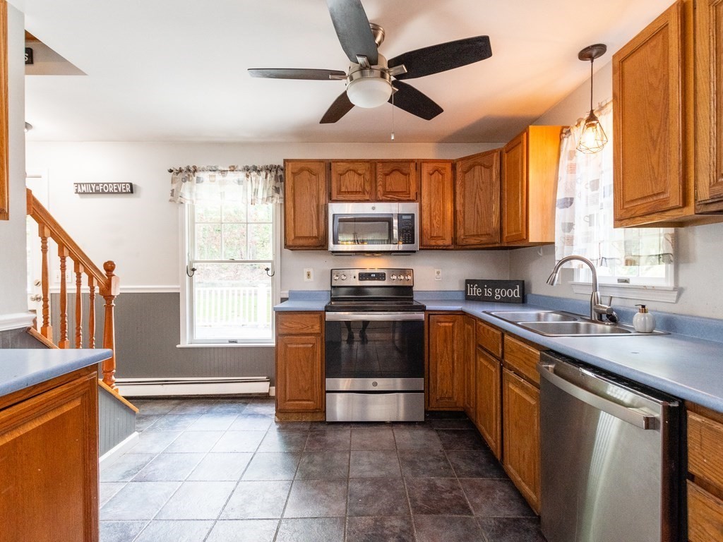 2 Columbia Road Billerica, MA 01821 - Photo 5 of 30 a kitchen with stainless steel appliances granite countertop a stove sink and microwave