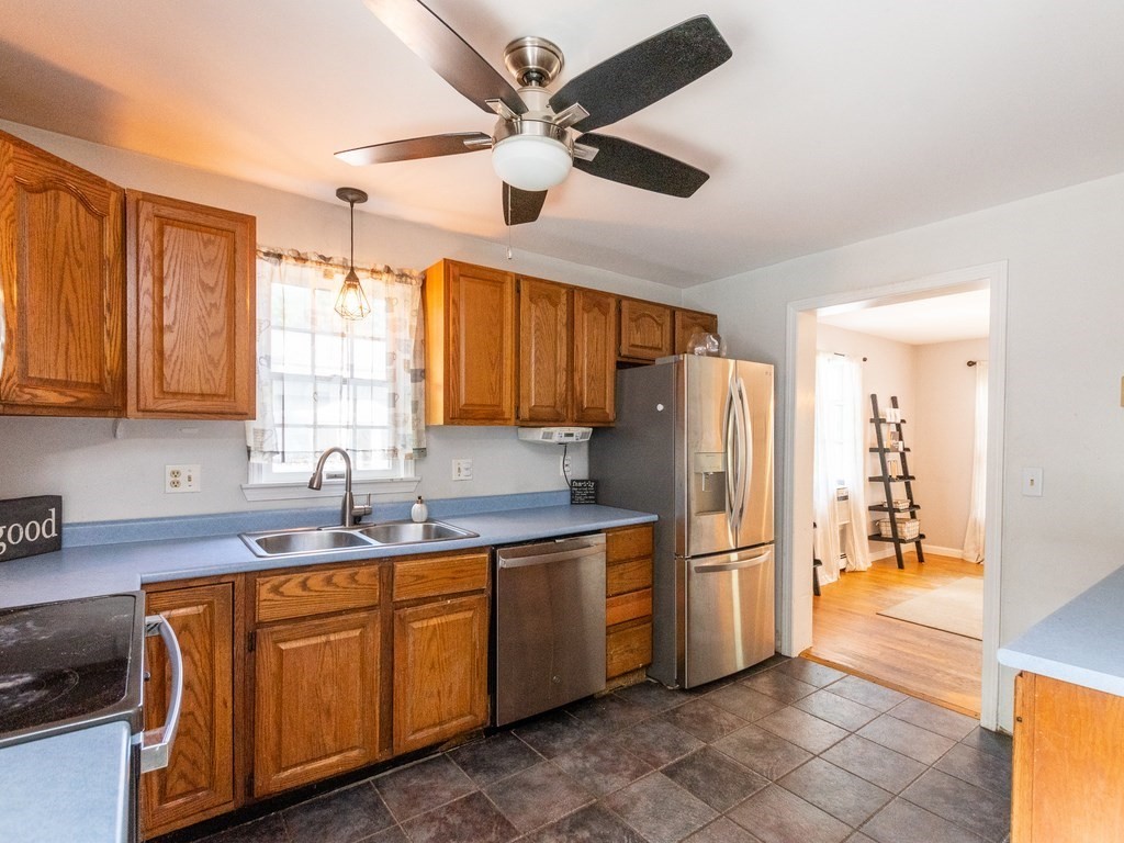 2 Columbia Road Billerica, MA 01821 - Photo 7 of 30 a kitchen with stainless steel appliances granite countertop a refrigerator a sink a stove with white cabinets