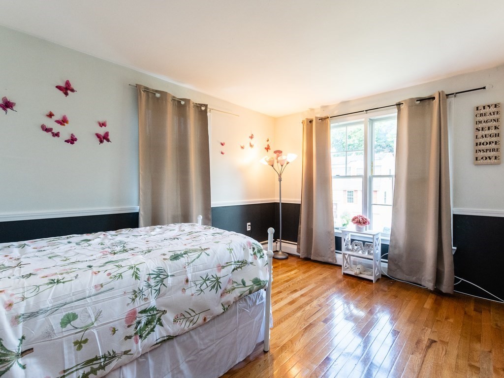 2 Columbia Road Billerica, MA 01821 - Photo 10 of 30 a bedroom with a bed and wooden floor
