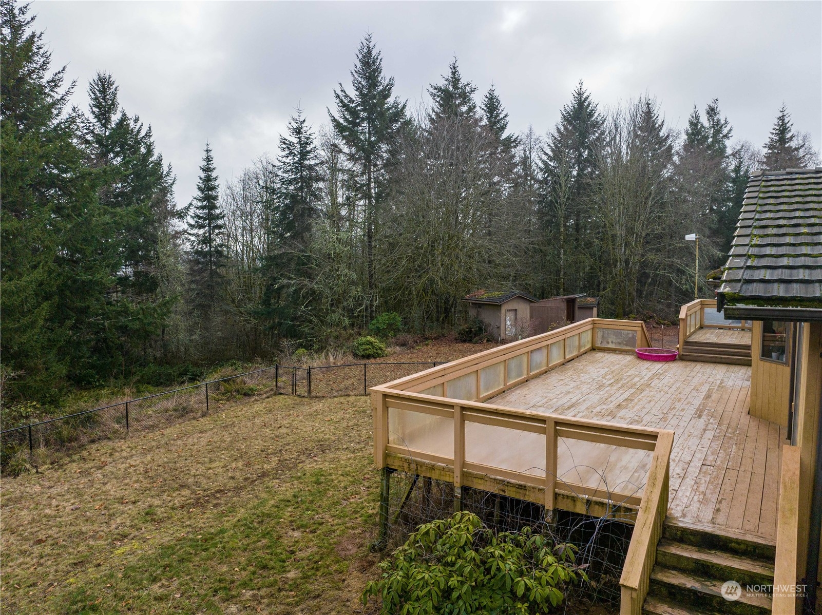 133 Ridgeview Road Chehalis, WA 98532 - Photo 24 of 32 a view of a roof deck with table and chairs a barbeque with wooden floor and fence
