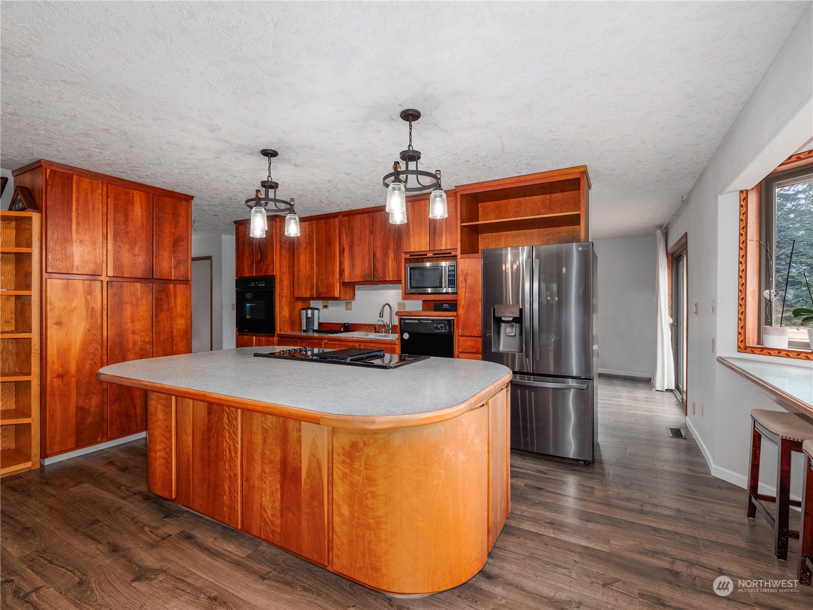 133 Ridgeview Road Chehalis, WA 98532 - Photo 4 of 32 a kitchen with stainless steel appliances a refrigerator a sink dishwasher a stove and a dining table with wooden floor