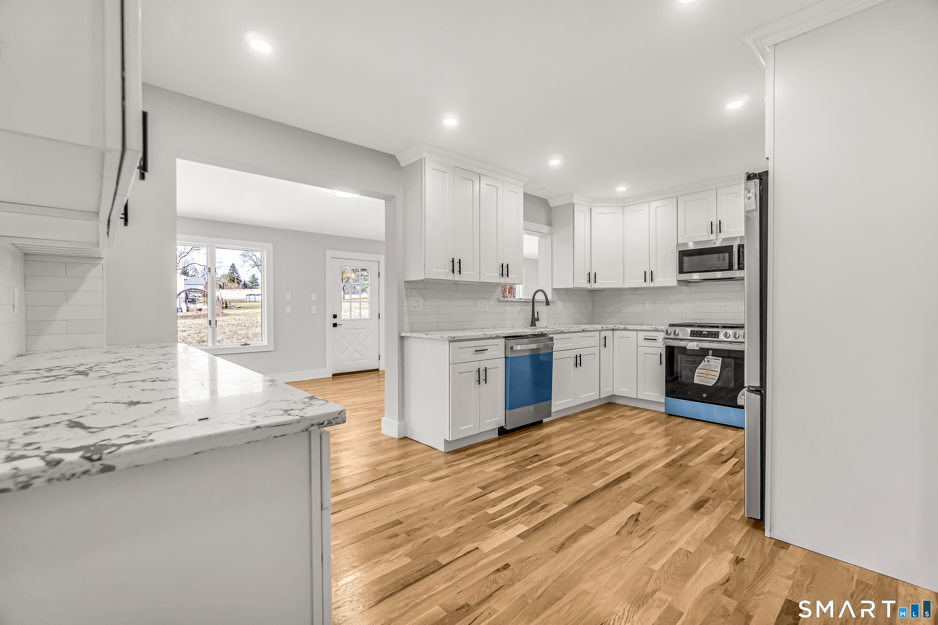 2 Rolf Drive Danbury, CT 06810 - Photo 11 of 32 a kitchen with stainless steel appliances granite countertop a stove top oven a sink and a refrigerator