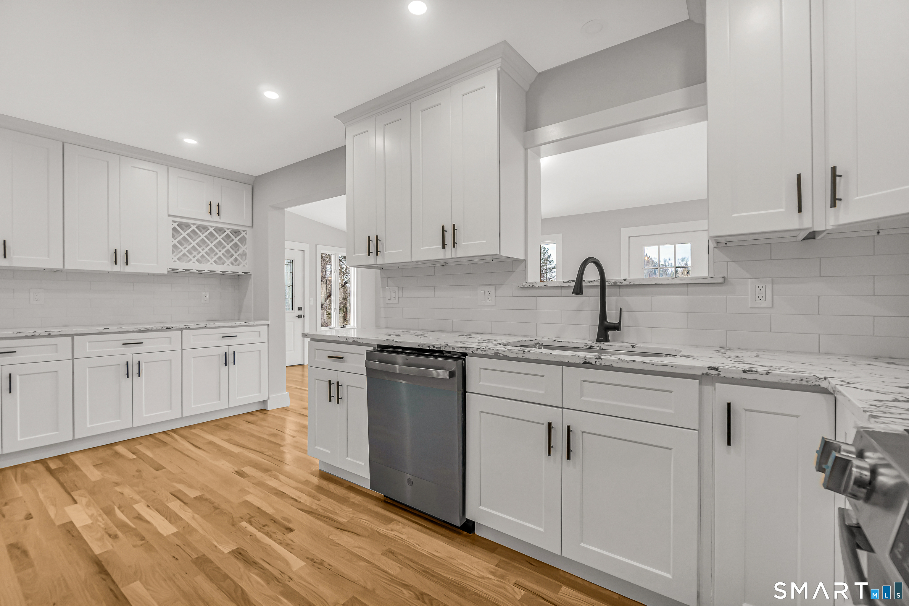 2 Rolf Drive Danbury, CT 06810 - Photo 12 of 32 a kitchen with white cabinets granite counter tops and a sink