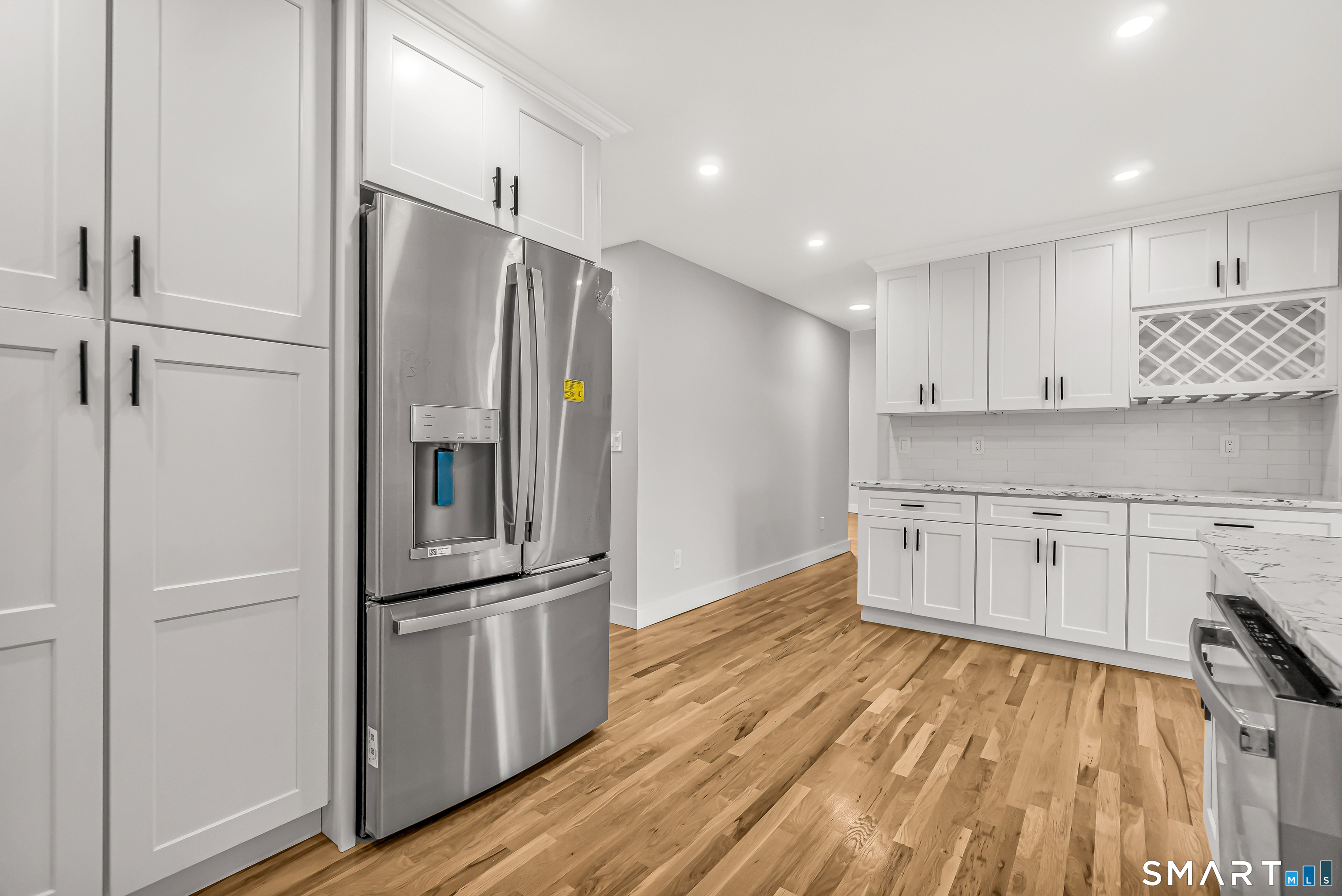 2 Rolf Drive Danbury, CT 06810 - Photo 13 of 32 a kitchen with kitchen island wooden floors appliances and cabinets