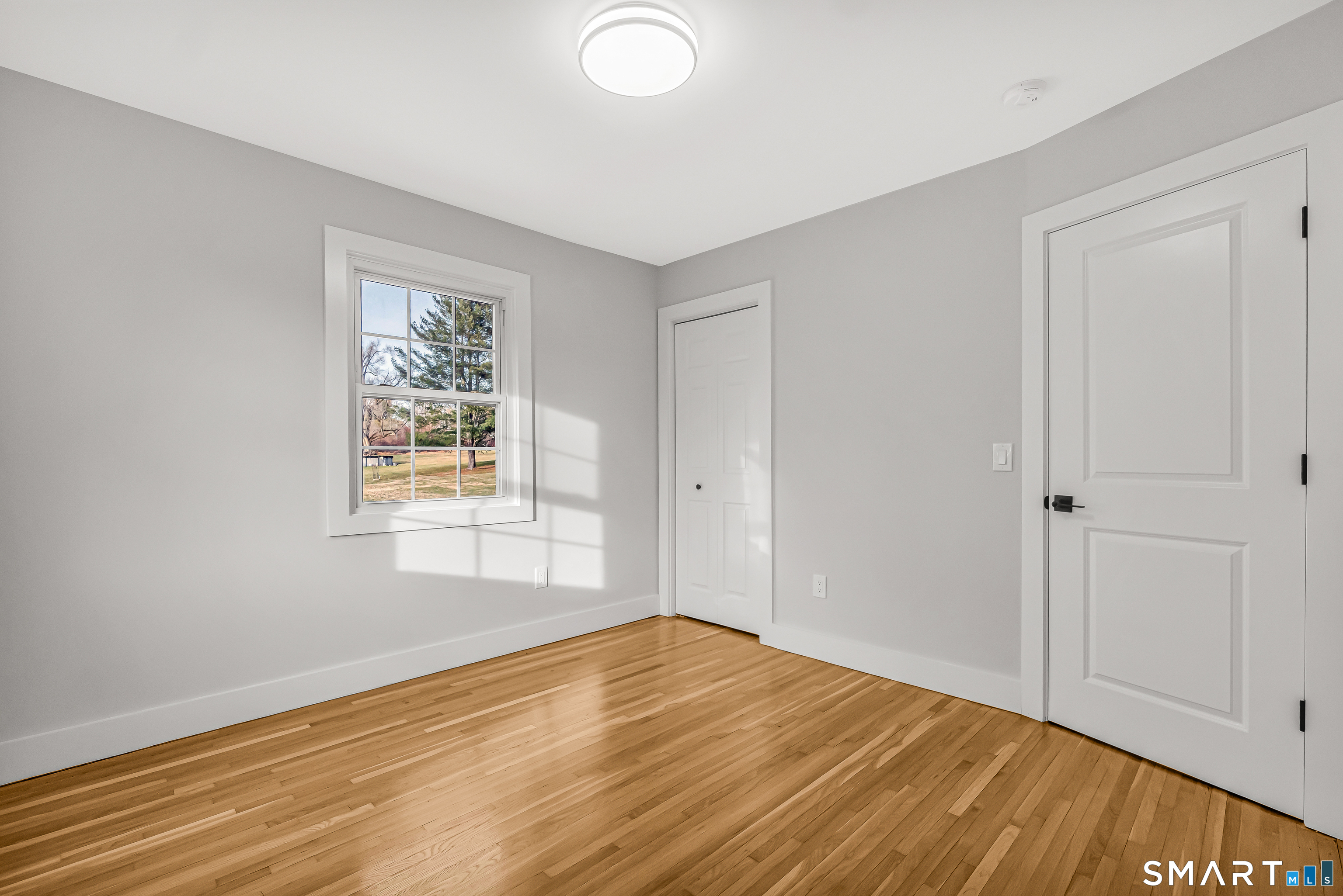 2 Rolf Drive Danbury, CT 06810 - Photo 24 of 32 a view of empty room with wooden floor and fan