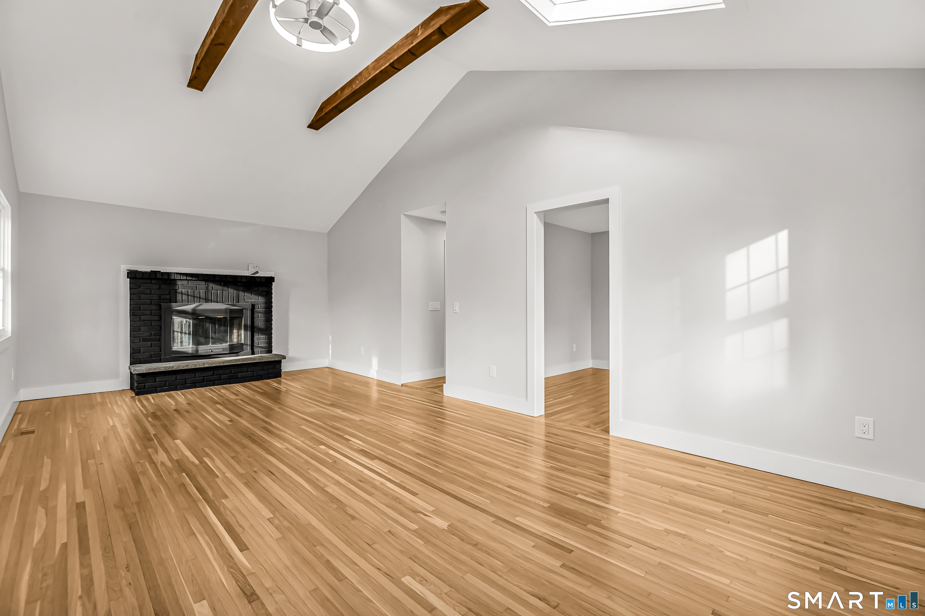 2 Rolf Drive Danbury, CT 06810 - Photo 10 of 32 a view of an empty room with wooden floor and a window