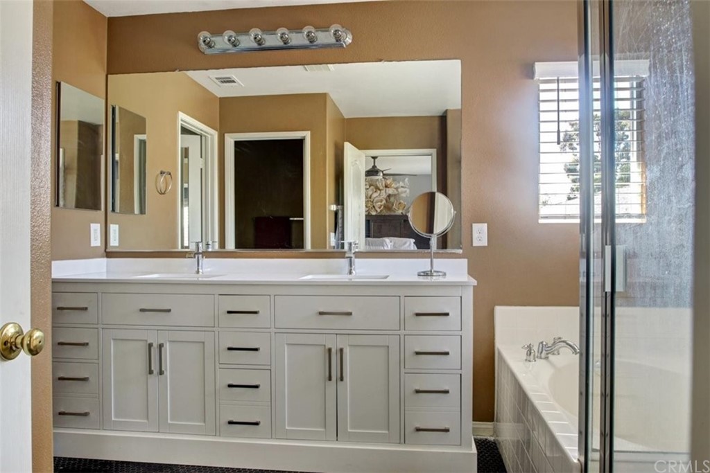 973 Thicket Drive Carson, CA 90746 - Photo 11 of 32 a bathroom with a granite countertop sink vanity and mirror
