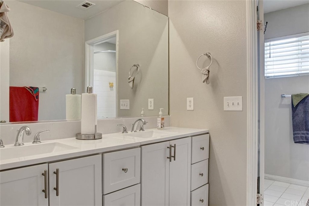 973 Thicket Drive Carson, CA 90746 - Photo 29 of 32 a bathroom with double sink and a mirror