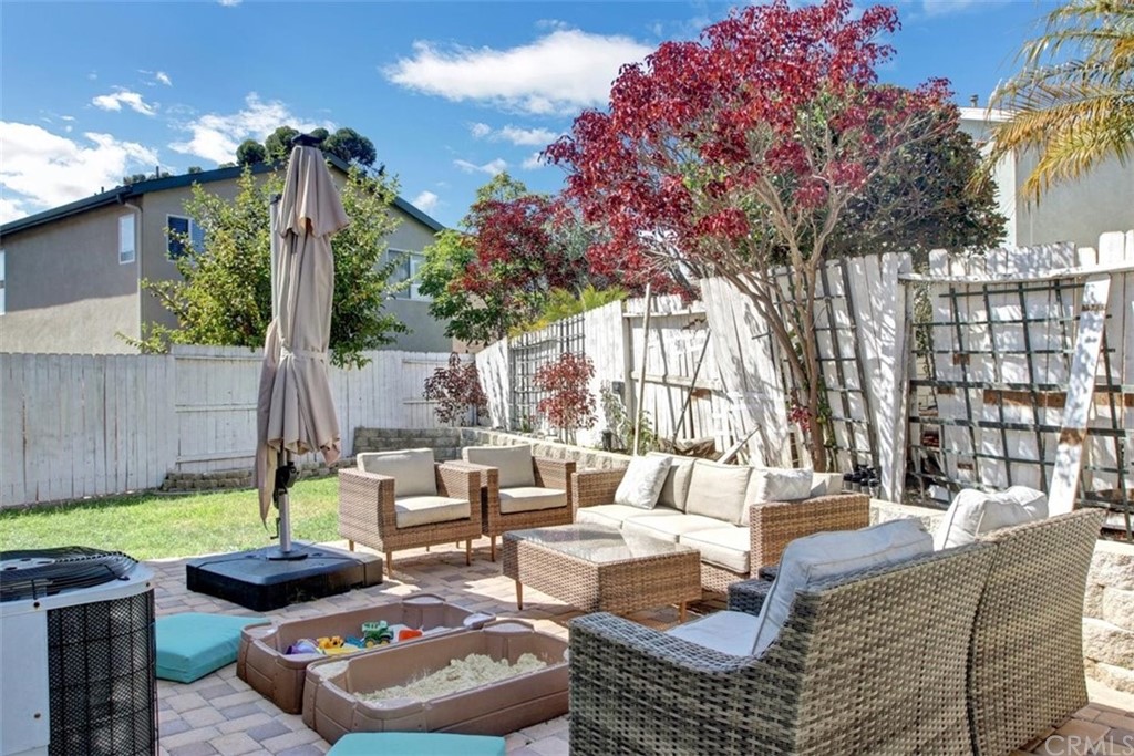 973 Thicket Drive Carson, CA 90746 - Photo 31 of 32 a view of a patio with couches chairs and a fire pit and large trees
