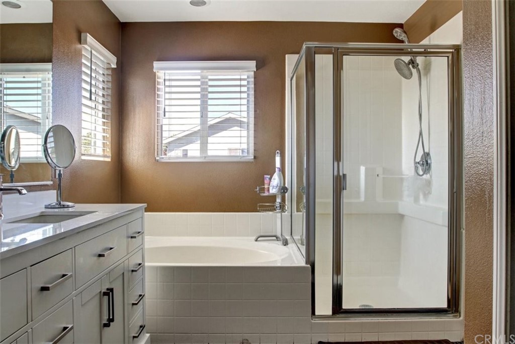 973 Thicket Drive Carson, CA 90746 - Photo 10 of 32 a bathroom with a granite countertop sink a mirror and a bathtub