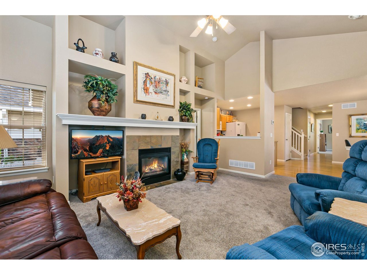 128 Bayside Circle Windsor, CO 80550 - Photo 24 of 24 a living room with furniture and a fireplace