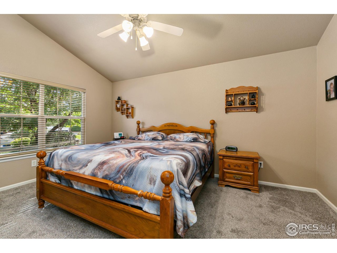 128 Bayside Circle Windsor, CO 80550 - Photo 11 of 24 a bed sitting in a bedroom next to a window