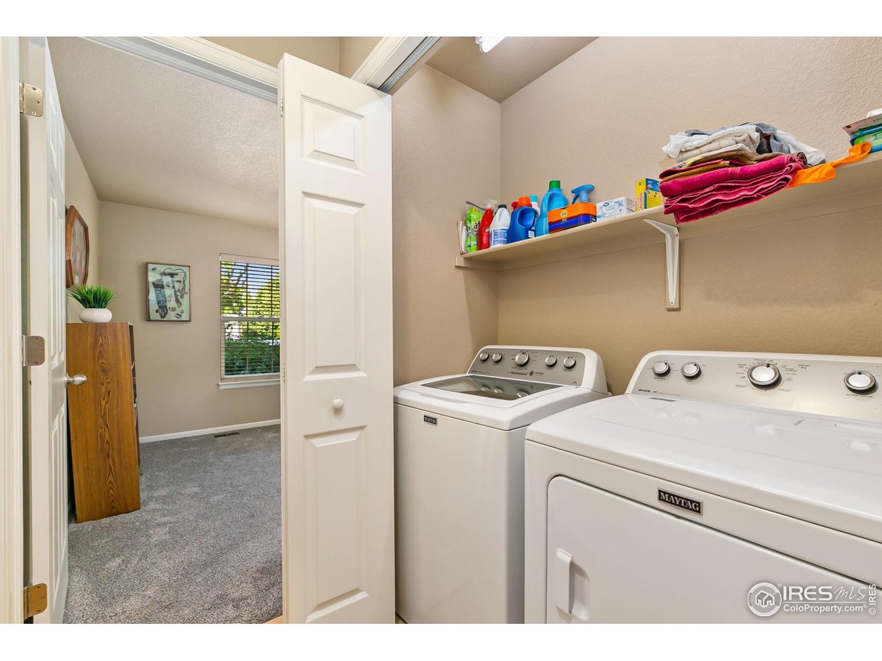 128 Bayside Circle Windsor, CO 80550 - Photo 13 of 24 a utility room with dryer and washer