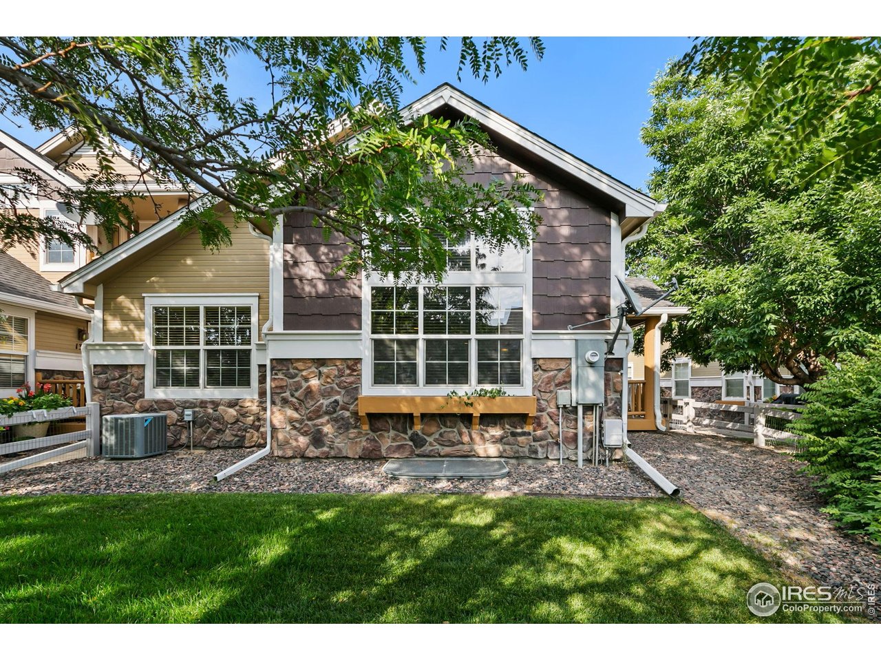 a view of a house with a yard and sitting area