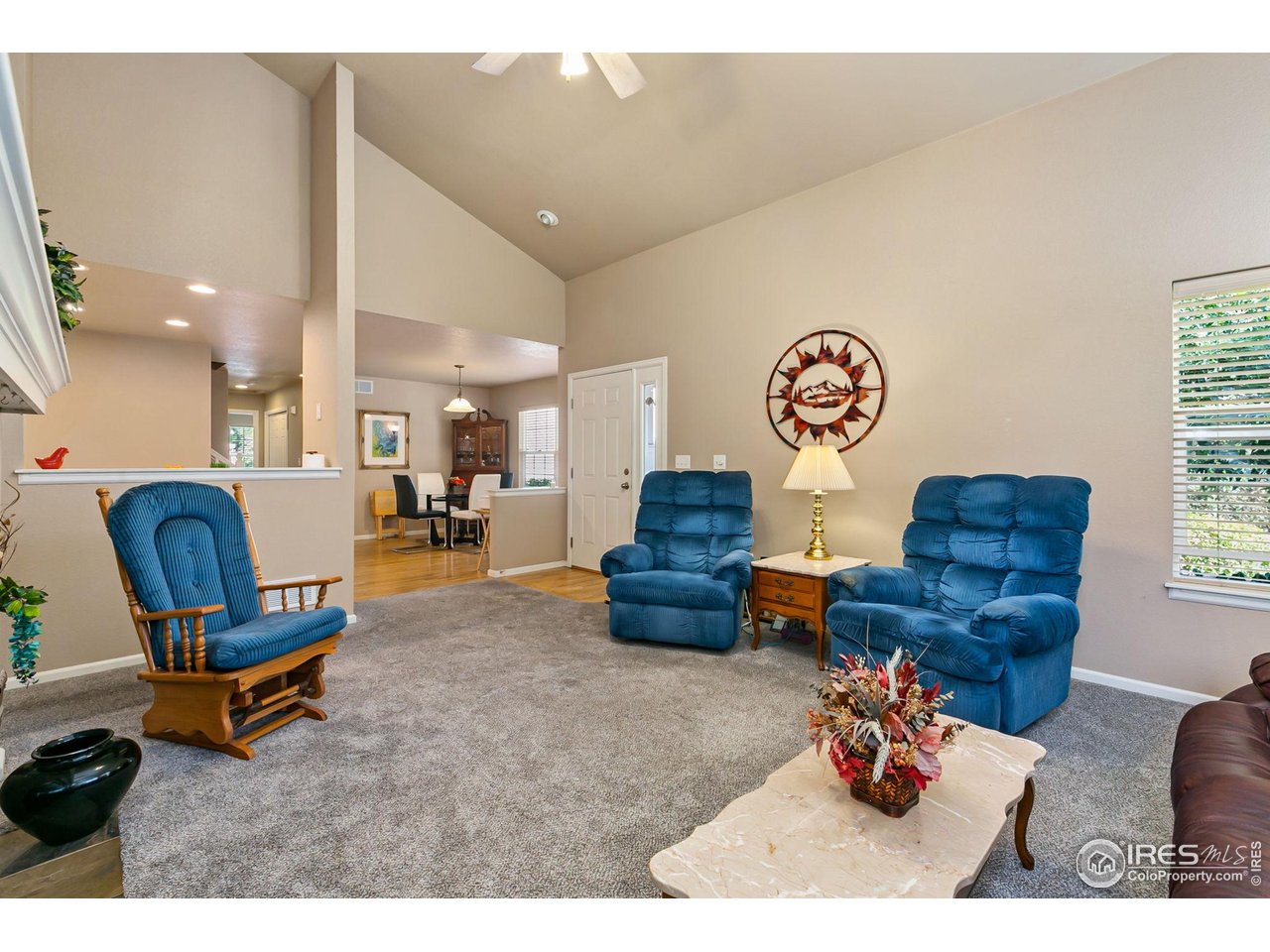 128 Bayside Circle Windsor, CO 80550 - Photo 5 of 24 a living room with furniture and a dining table