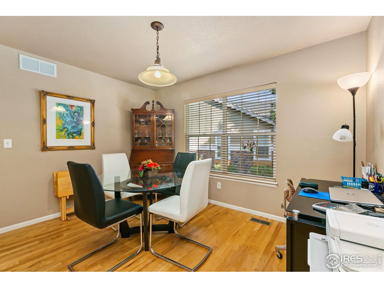 128 Bayside Circle Windsor, CO 80550 - Photo 6 of 24 a living room with furniture a flat screen tv and a table