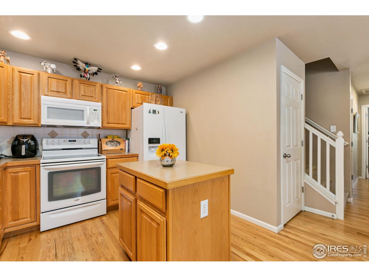 128 Bayside Circle Windsor, CO 80550 - Photo 8 of 24 a kitchen with a stove a refrigerator and a sink