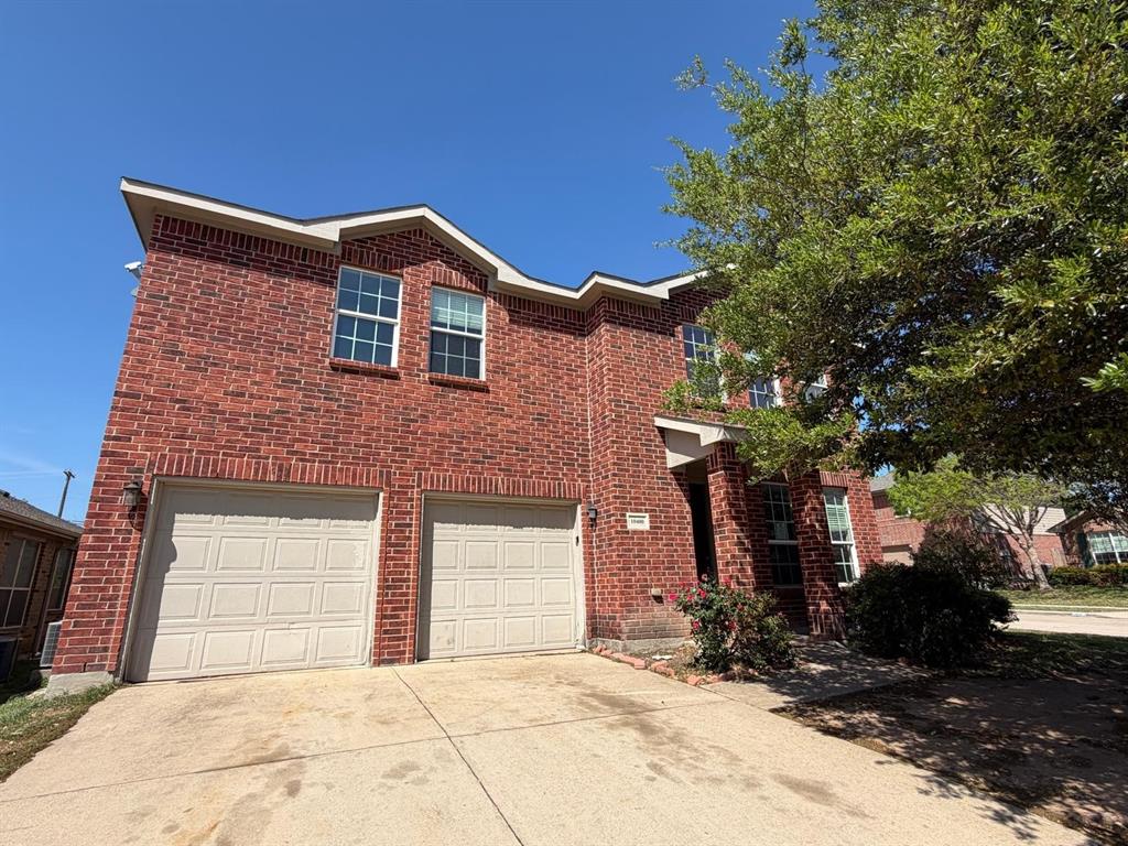 10400 Wagon Rut Court Fort Worth, TX 76108 - Photo 1 of 26 Traditional-style home featuring driveway, a garage, and brick siding