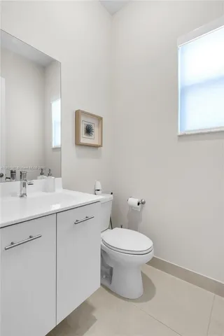 a bathroom with a double vanity sink mirror and shower