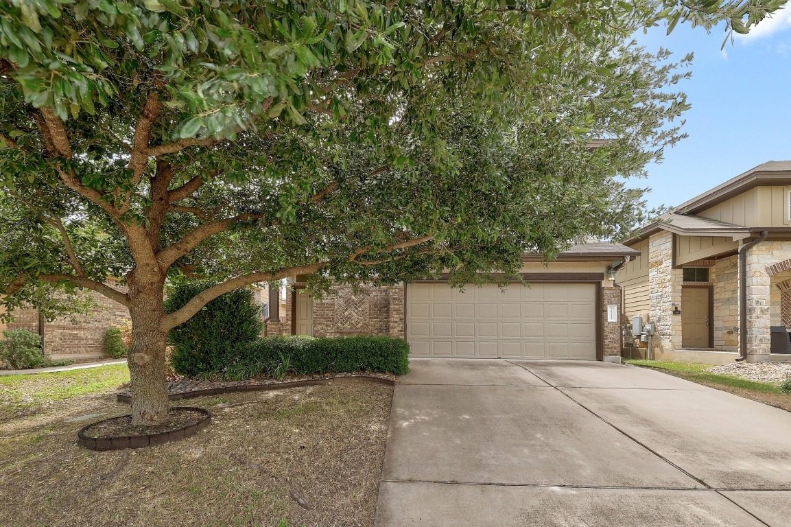 16233 Travesia Way Austin, TX 78728 - Photo 2 of 27 a house with a tree in front of it