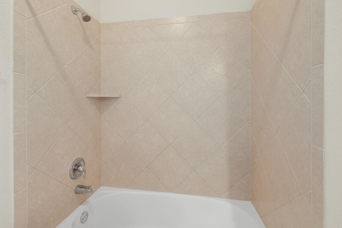 16233 Travesia Way Austin, TX 78728 - Photo 22 of 27 a bathroom with a white shower and a sink