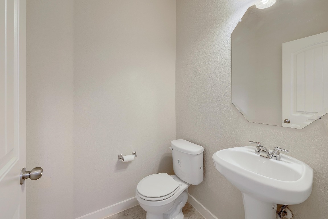 16233 Travesia Way Austin, TX 78728 - Photo 23 of 27 a bathroom with a sink a toilet and mirror