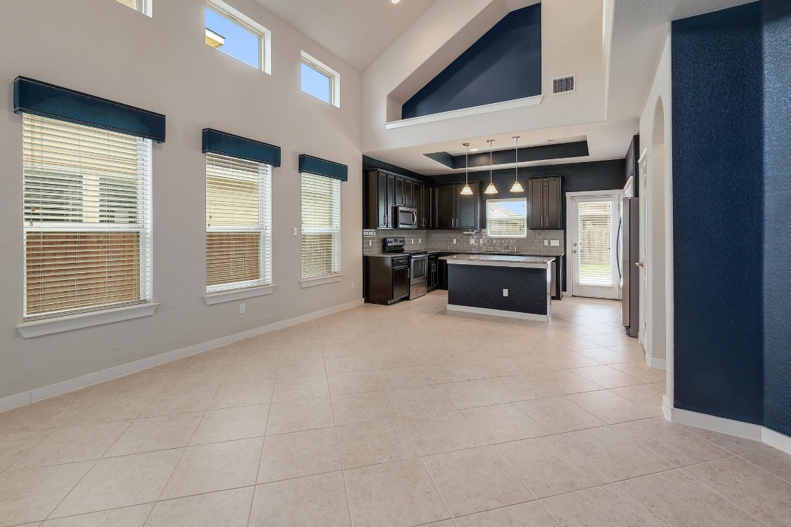 16233 Travesia Way Austin, TX 78728 - Photo 5 of 27 a large kitchen with a stove