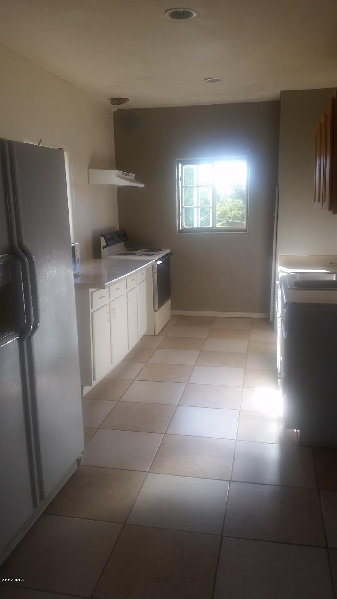 1165 East 10th Street Douglas, AZ 85607 - Photo 25 of 54 a view of an empty room with a kitchen