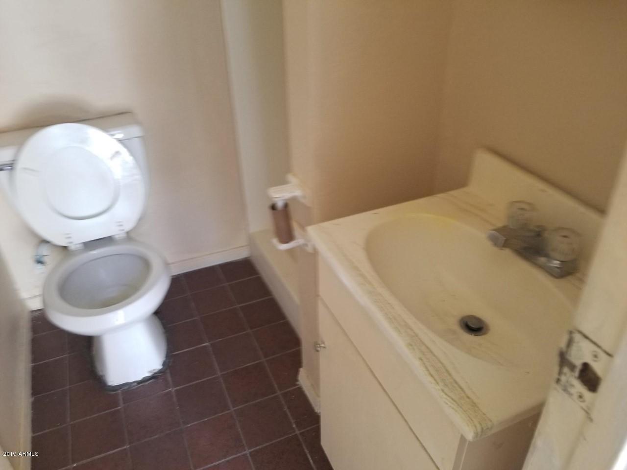 1165 East 10th Street Douglas, AZ 85607 - Photo 31 of 54 a bathroom with a sink and toilet