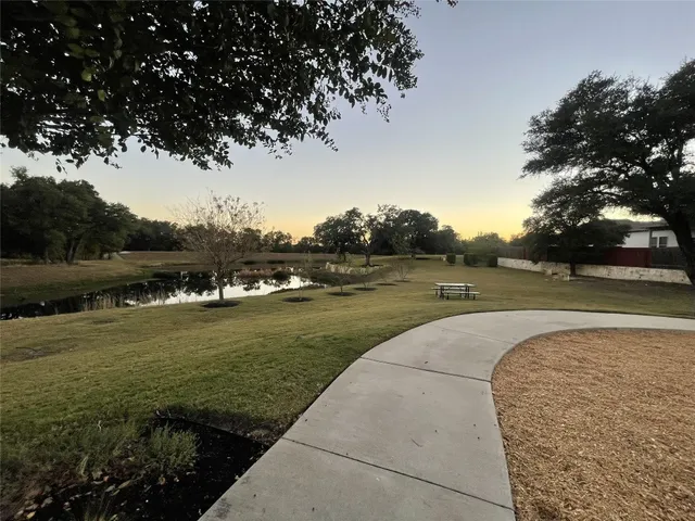 a front view of a building with a garden
