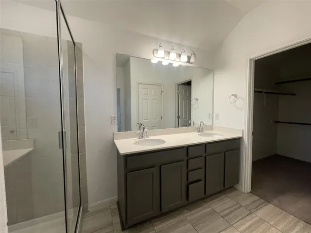 a bathroom with a double vanity sink and a mirror