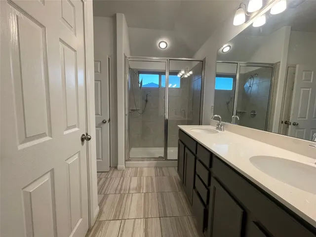 a bathroom with a double vanity sink and mirror