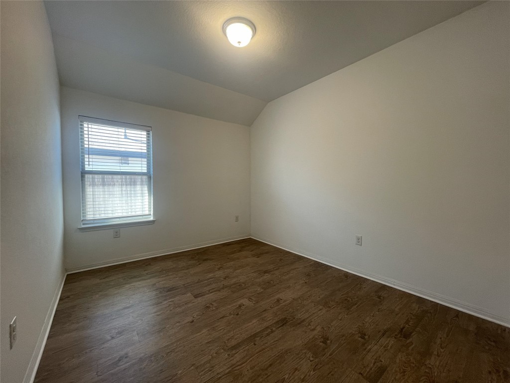 308 Somerville Street Leander, TX 78641 - Photo 10 of 24 Unfurnished room with lofted ceiling and dark wood-style flooring