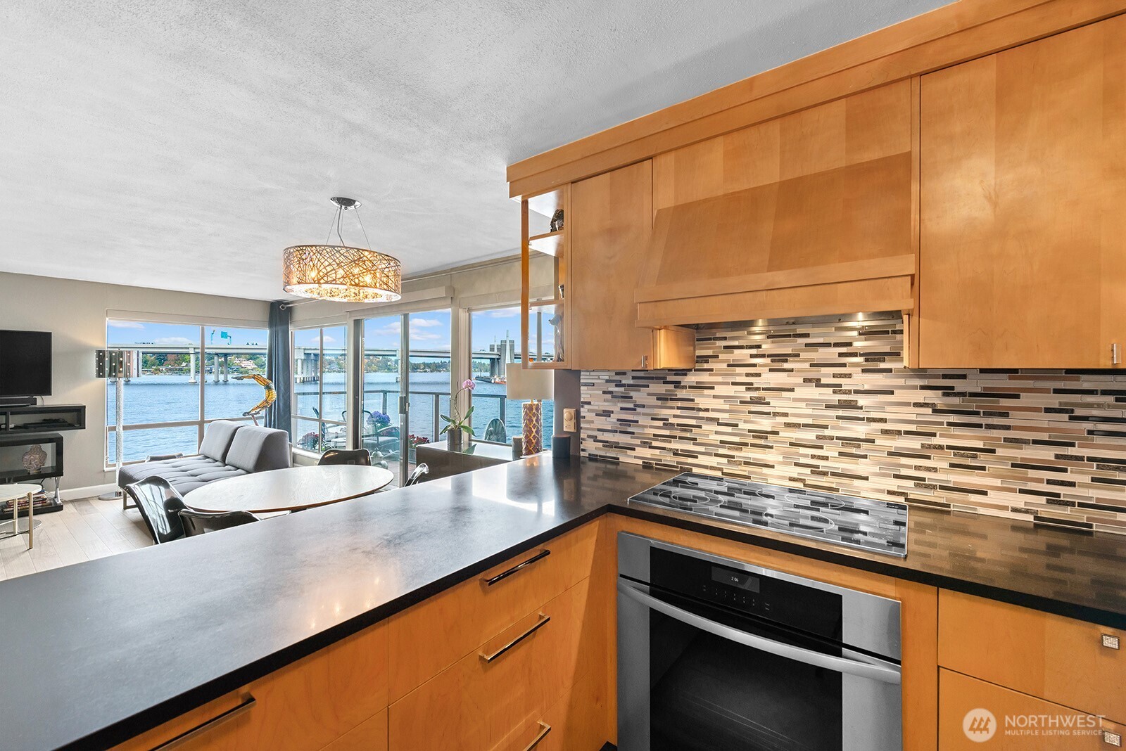 2360 43rd Avenue East, Unit 214 Seattle, WA 98112 - Photo 11 of 34 a kitchen with stainless steel appliances a sink and a large window