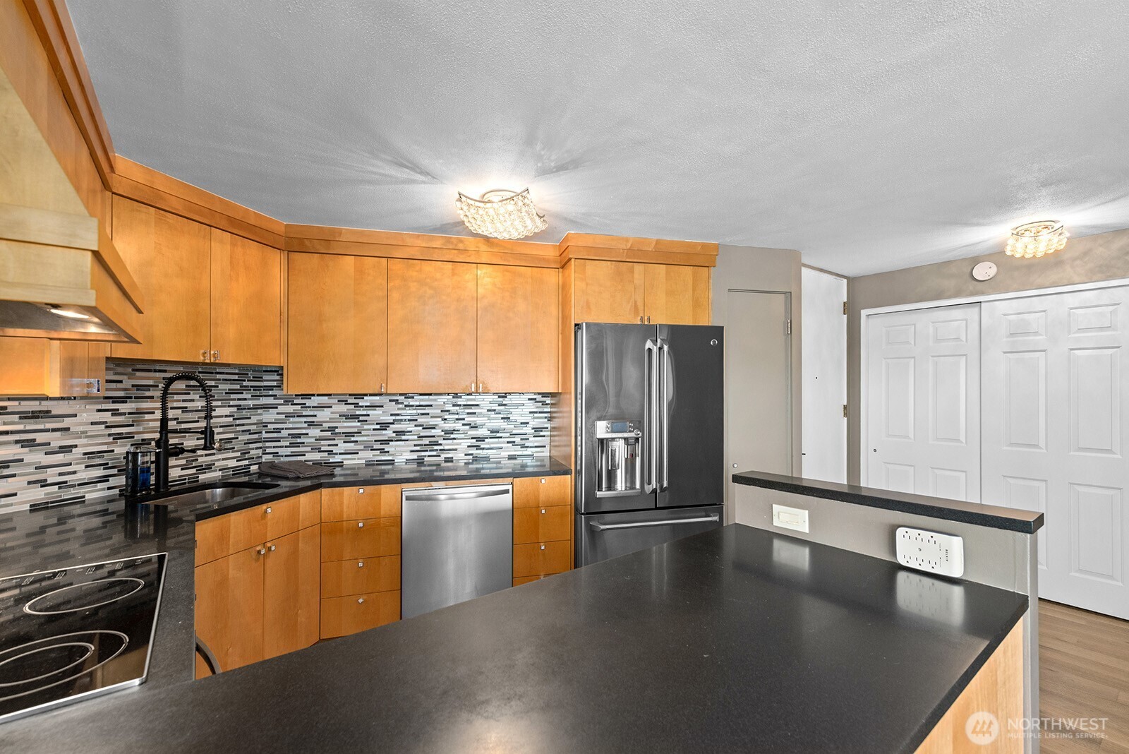 2360 43rd Avenue East, Unit 214 Seattle, WA 98112 - Photo 13 of 34 a kitchen with stainless steel appliances wooden floor and a refrigerator