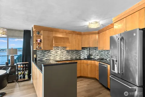 a kitchen with stainless steel appliances granite countertop a refrigerator and a sink