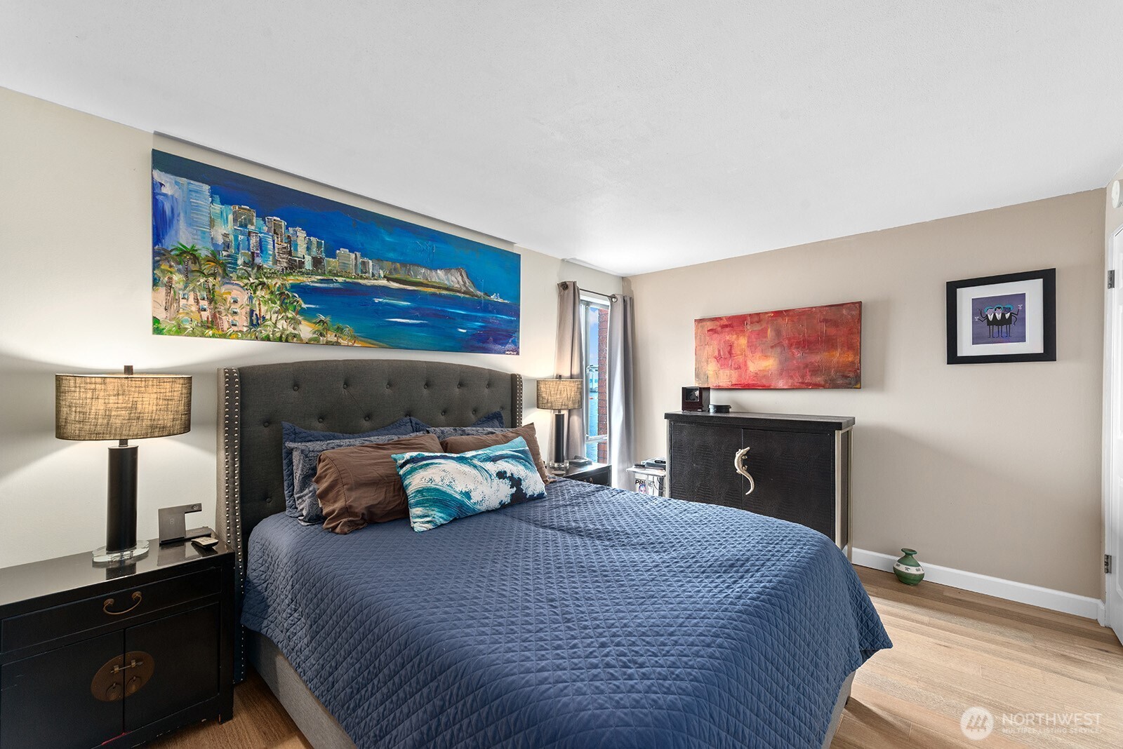 2360 43rd Avenue East, Unit 214 Seattle, WA 98112 - Photo 17 of 34 a bedroom with a bed and a flat screen tv