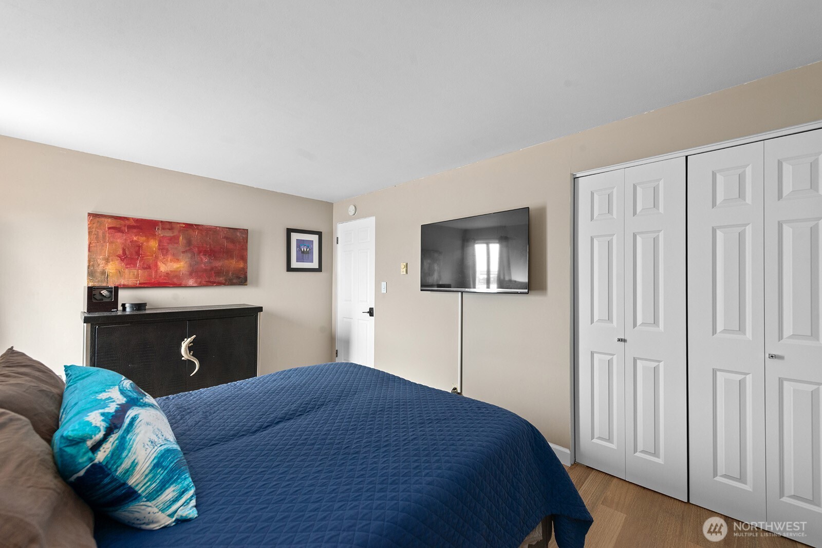 2360 43rd Avenue East, Unit 214 Seattle, WA 98112 - Photo 18 of 34 a bedroom with a bed and a flat screen tv