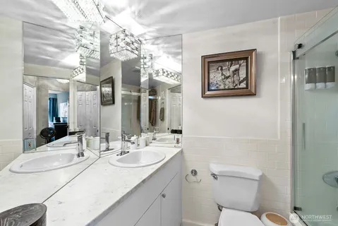 a bathroom with a sink vanity granite and toilet
