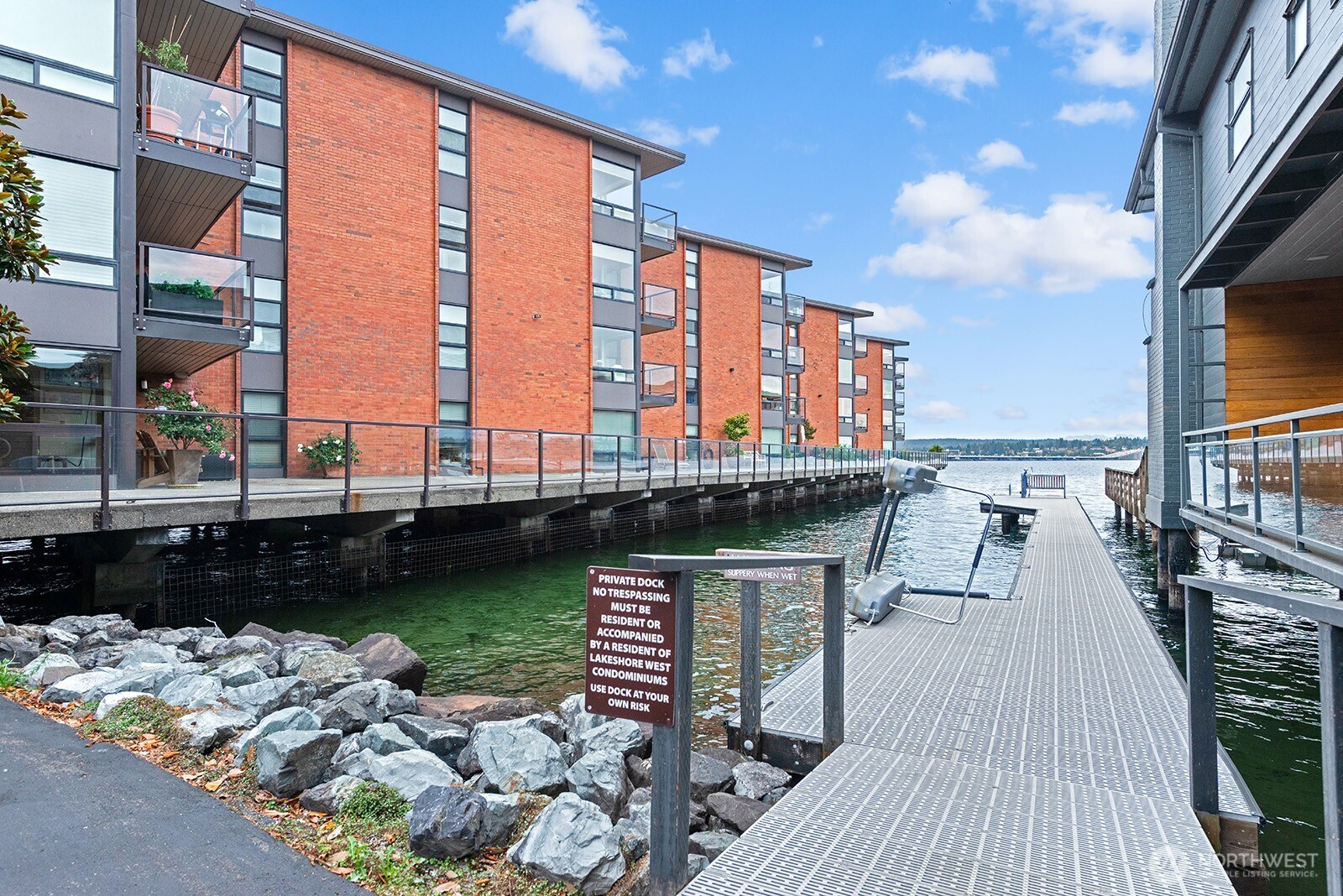 2360 43rd Avenue East, Unit 214 Seattle, WA 98112 - Photo 31 of 34 a view of a balcony with chairs and wooden floor