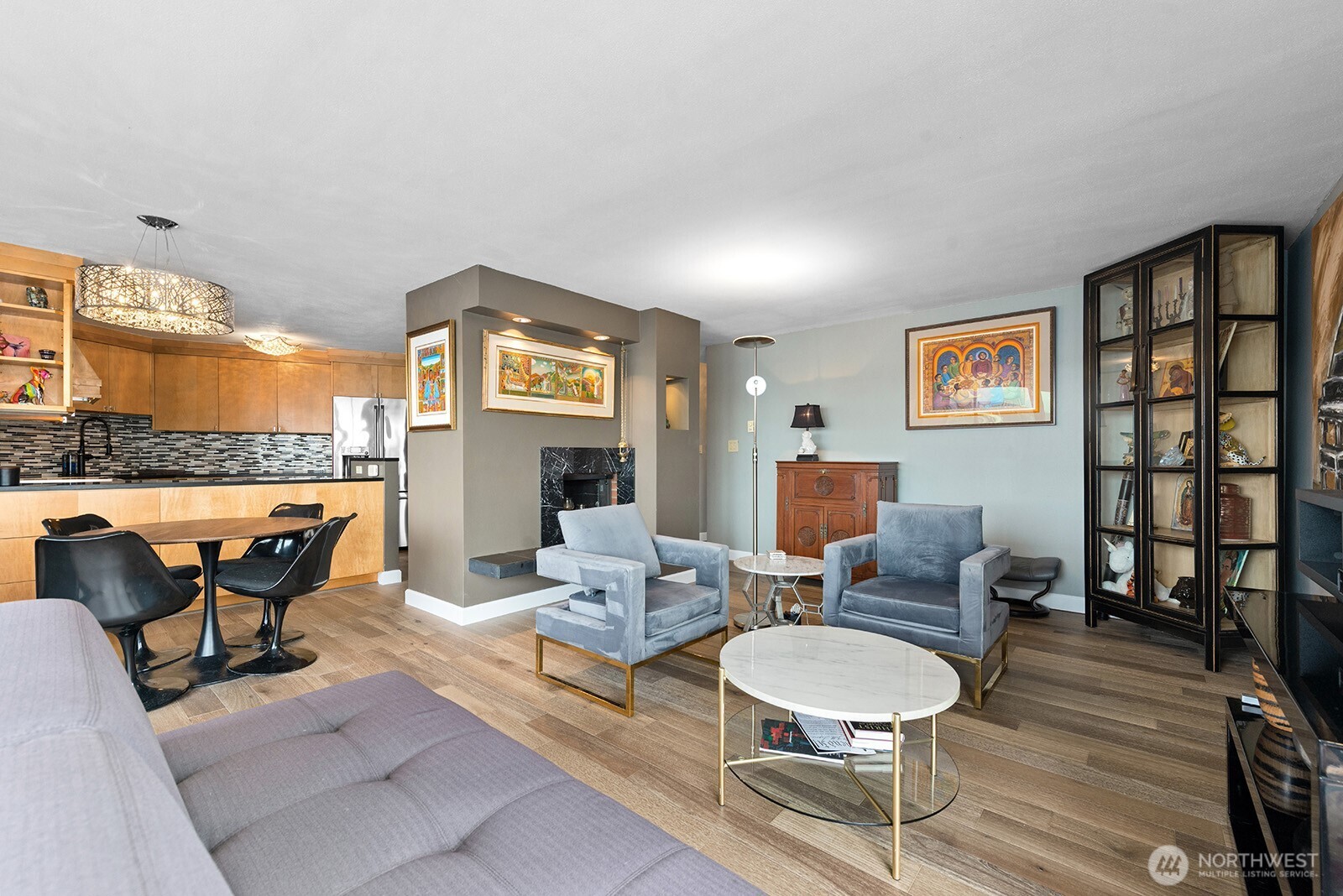 2360 43rd Avenue East, Unit 214 Seattle, WA 98112 - Photo 7 of 34 a living room with furniture a fireplace and kitchen view